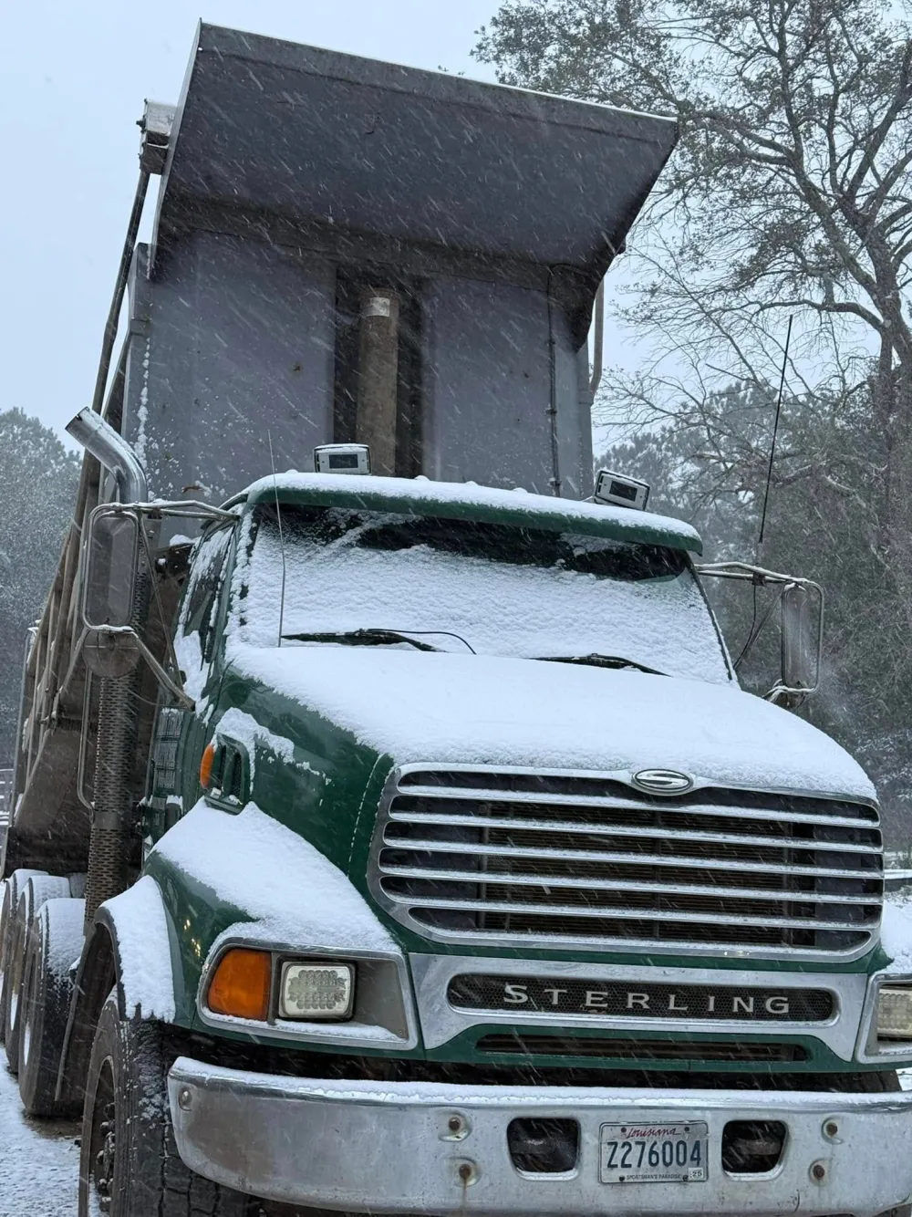Dump truck hauling excavated material off a Northshore construction site