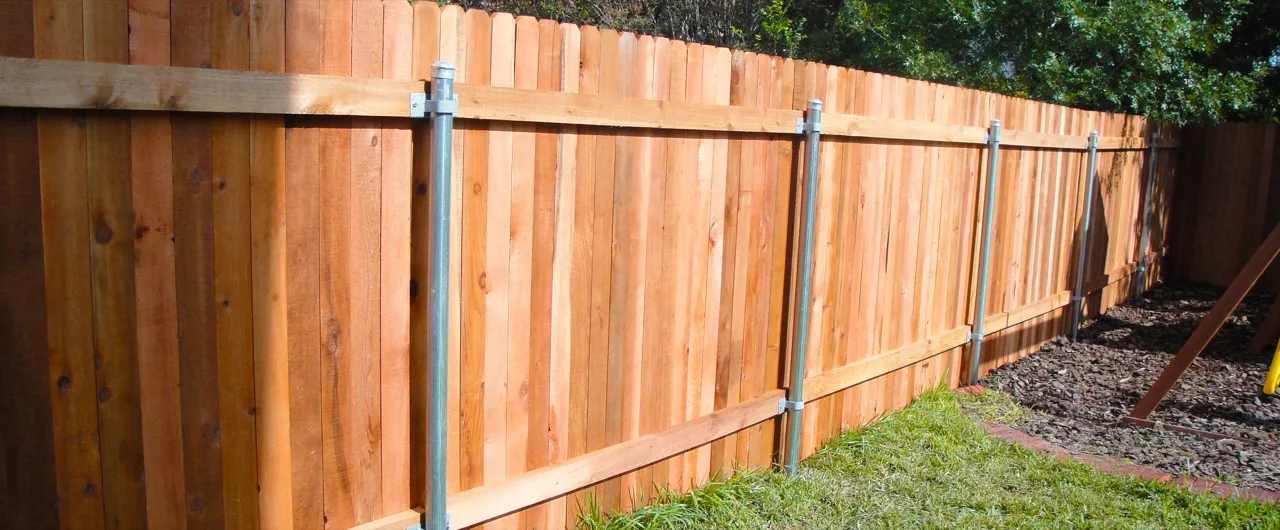 New wood privacy fence installed on a residential property near Covington, Louisiana