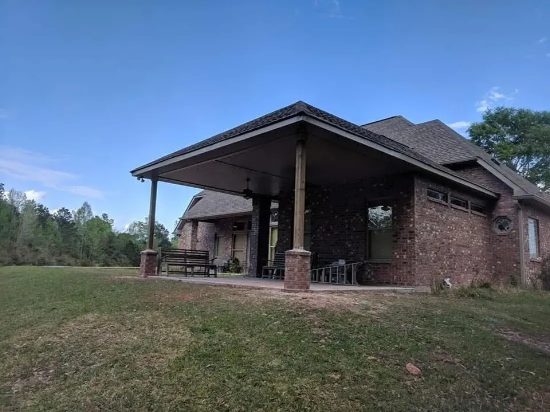 Covered outdoor pavilion attached to a brick home