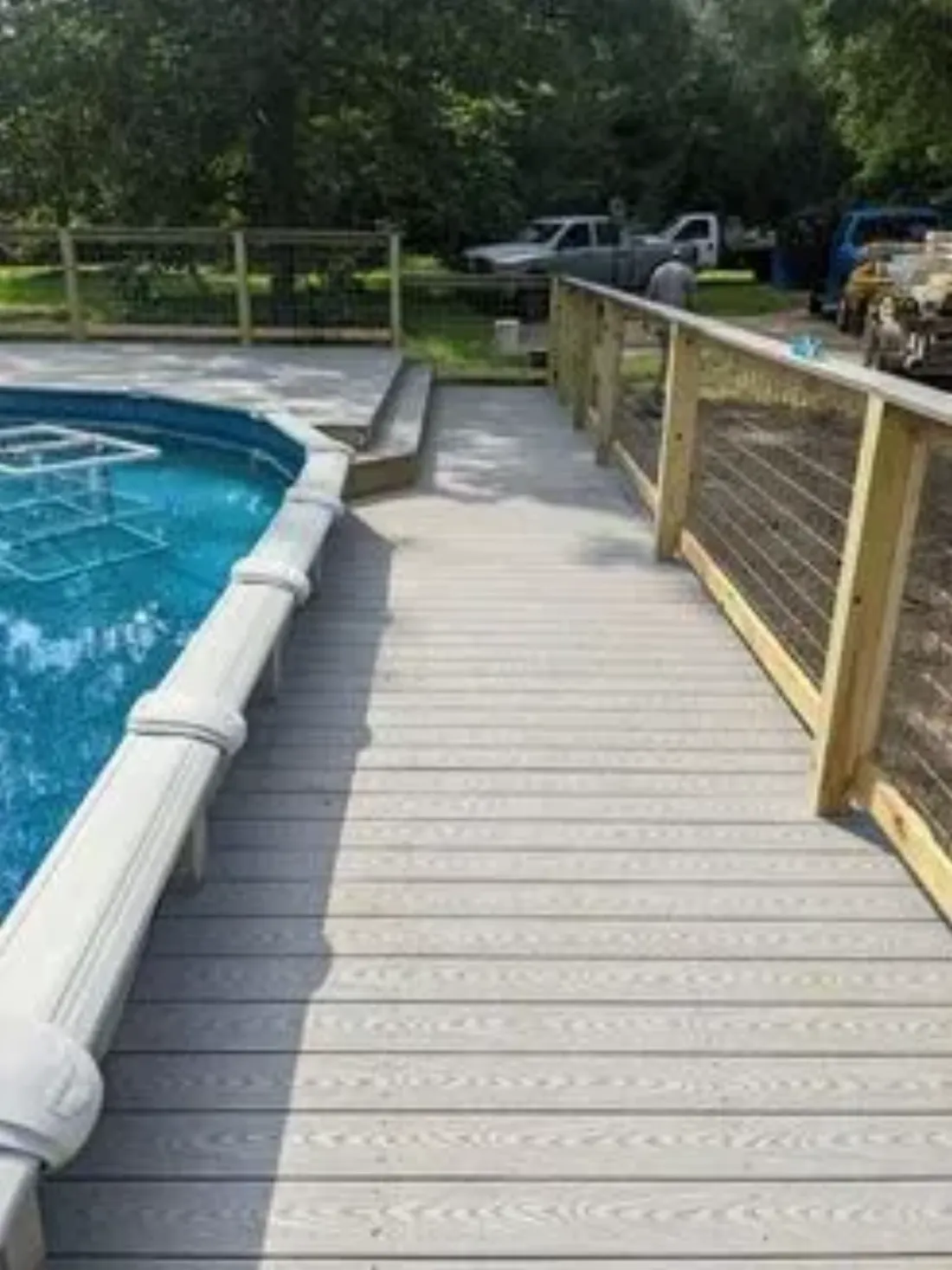 Composite deck built around a backyard pool